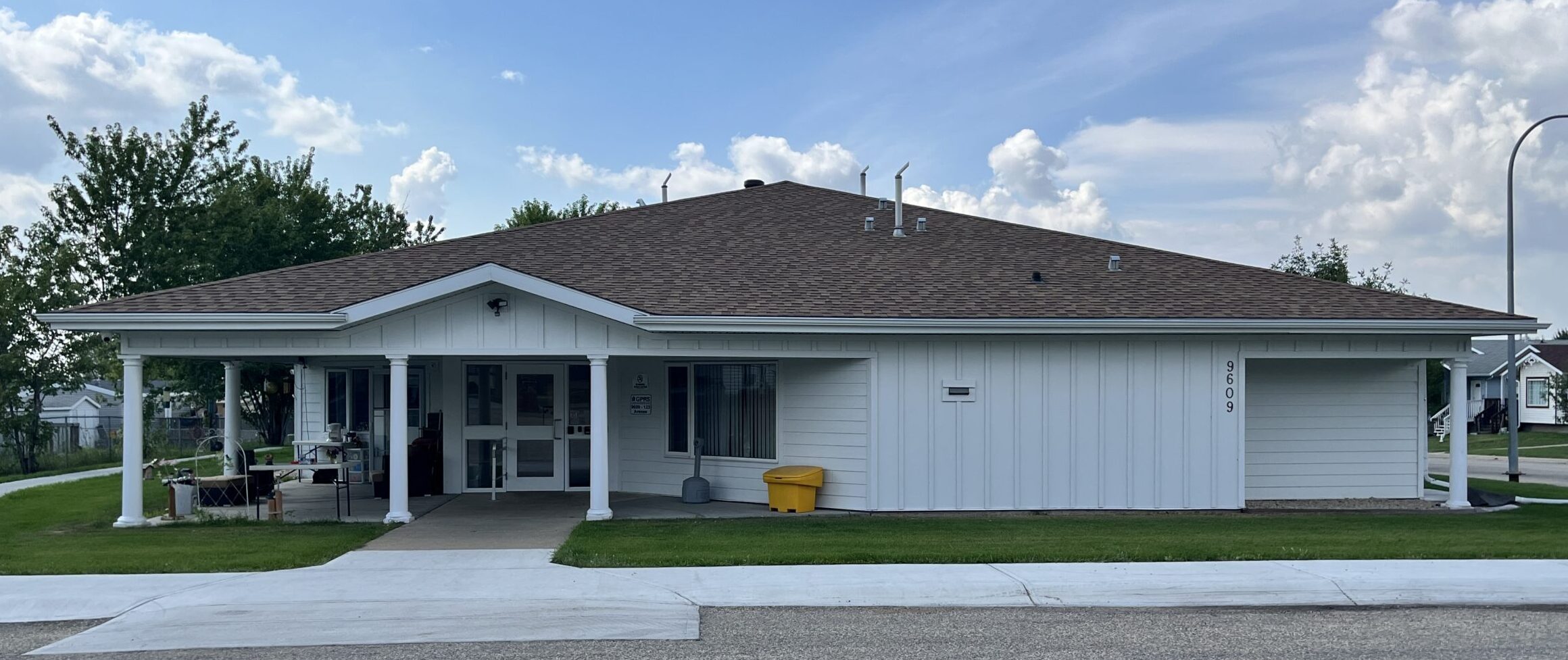 Accessible duplex housing in Grande Prairie's Crystal Ridge neighbourhood with covered entrance and paved driveway