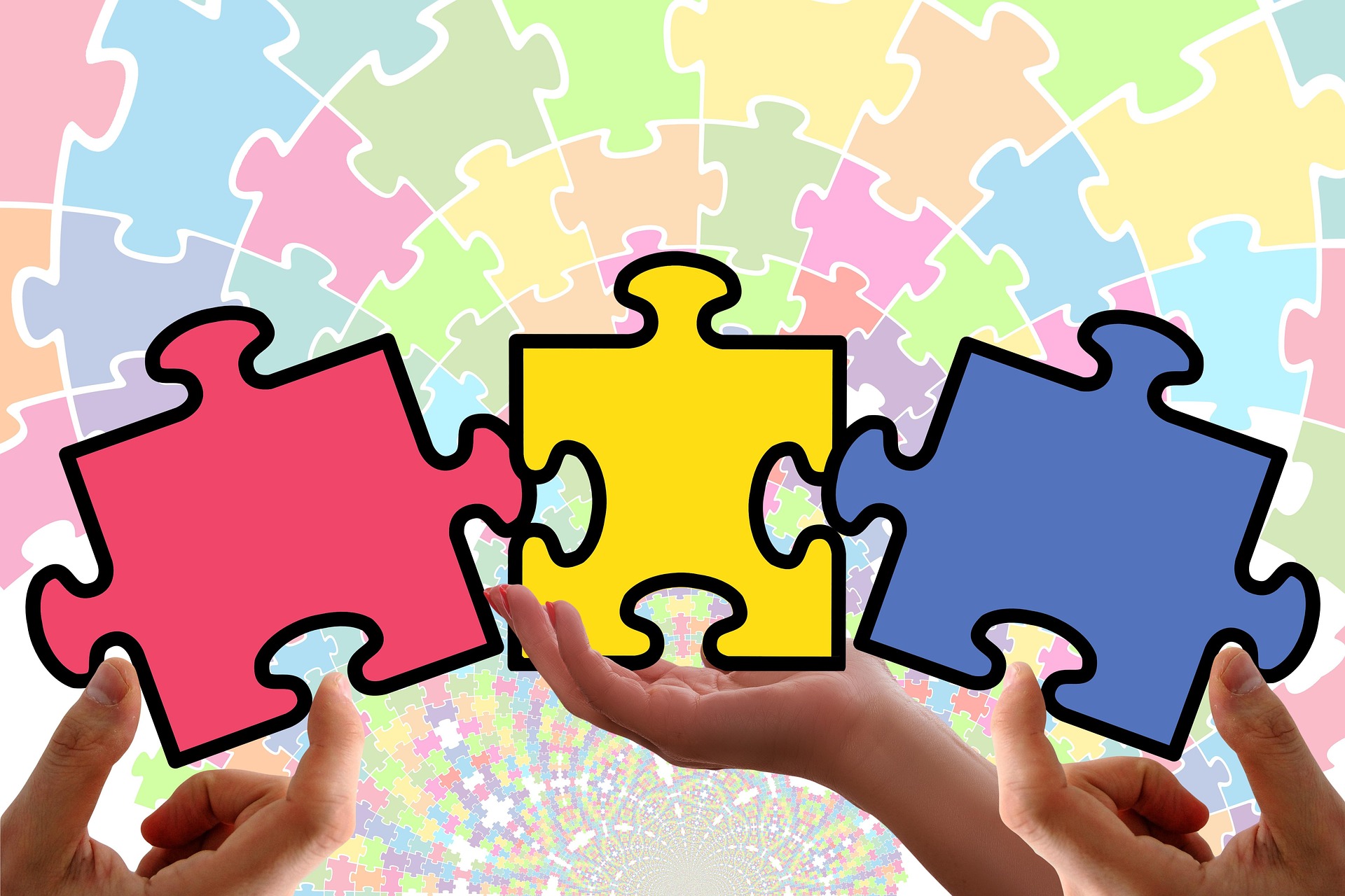 Three interlocking puzzle pieces held by hands